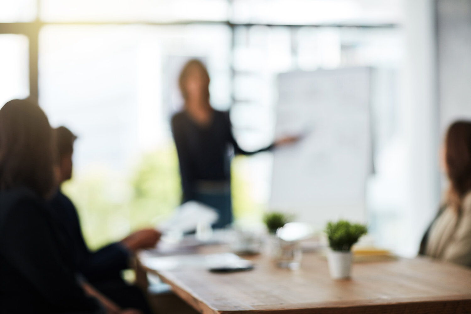 Defocussed shot of a team of businesspeople attending a meeting in the boardroom