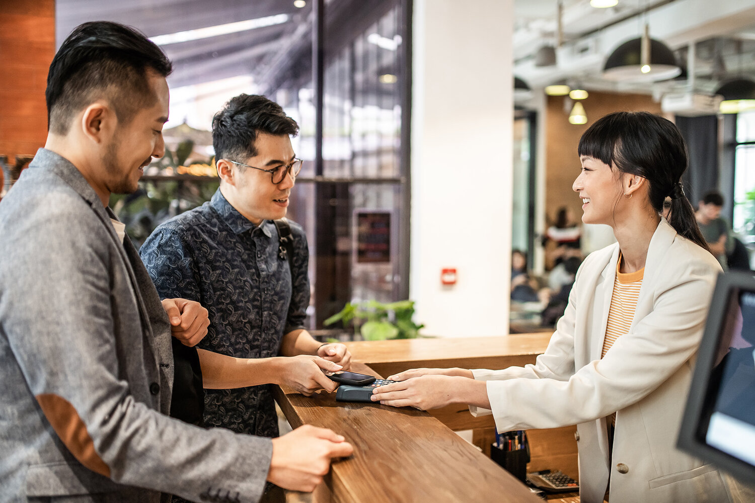 Receptionist helping 2 people