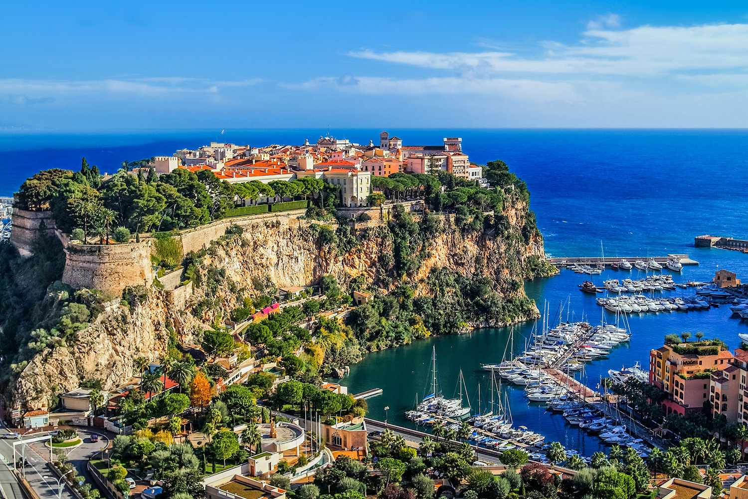 European port with boats docked and homes on a peninsula